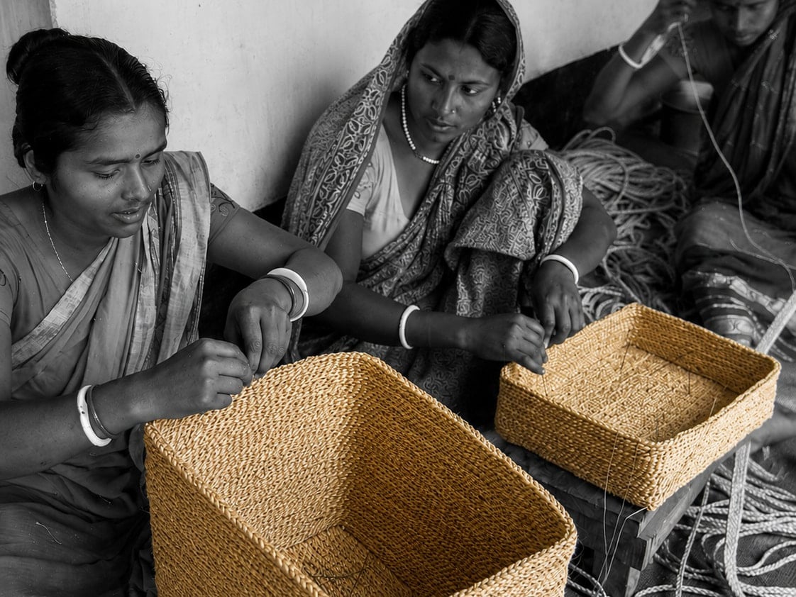 Women artisans hand-weaving jute baskets